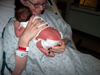 Talina holding newborn Sean - Plumber's buttcrack!